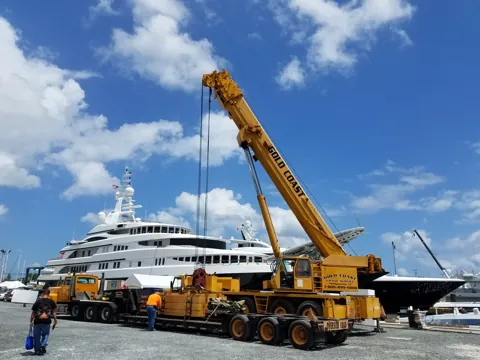 On-site crane handling alongside a yacht