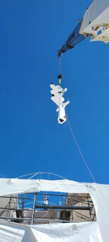 Crane lifting a yacht component above the deck