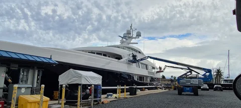 Man-lift access along the side of a yacht for polishing