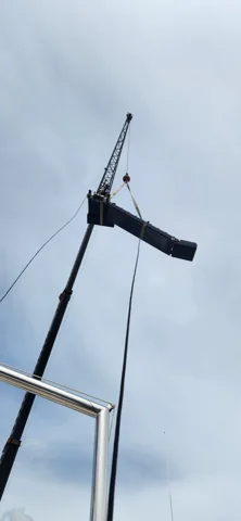 Crane lifting a side boarding ladder
