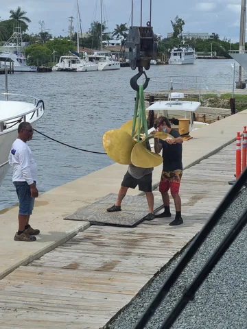 Crane handling a propeller at the dock