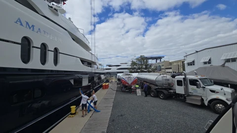 Fuel delivery truck positioned alongside a yacht