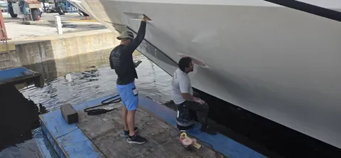 Hands-on exterior work alongside a yacht