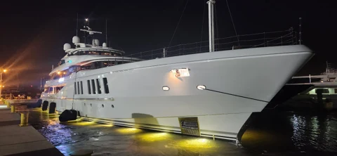 Illuminated yacht bow and reflections at night