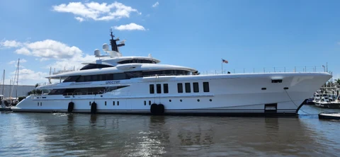 White superyacht alongside the dock under a blue sky