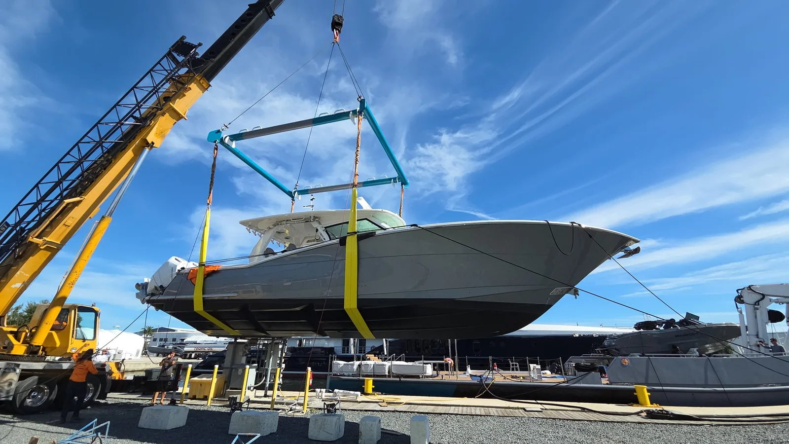 Crane lifting a tender alongside yachts at the Taylor Lane yard