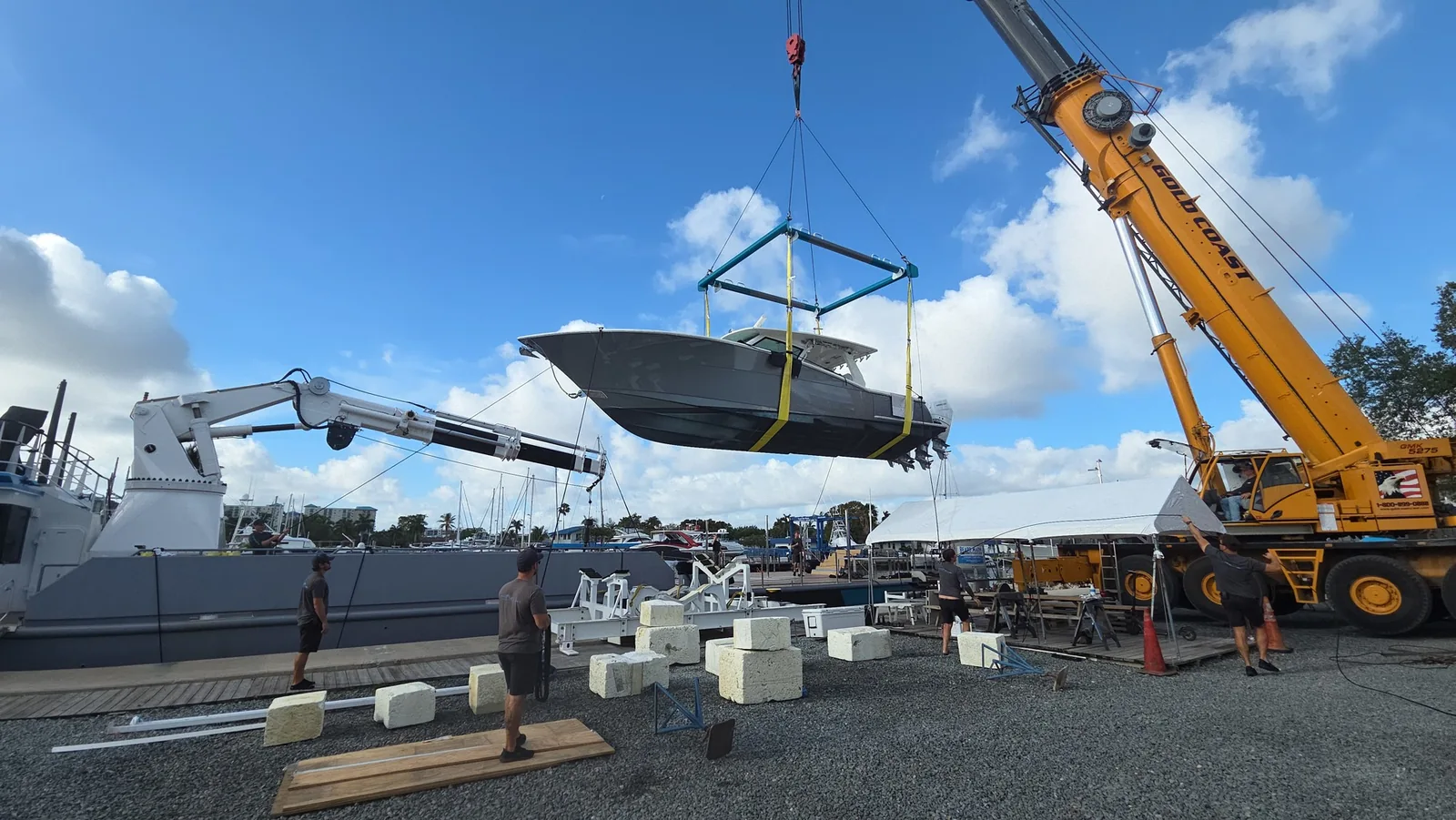 Crane handling equipment beside a yacht at Taylor Lane
